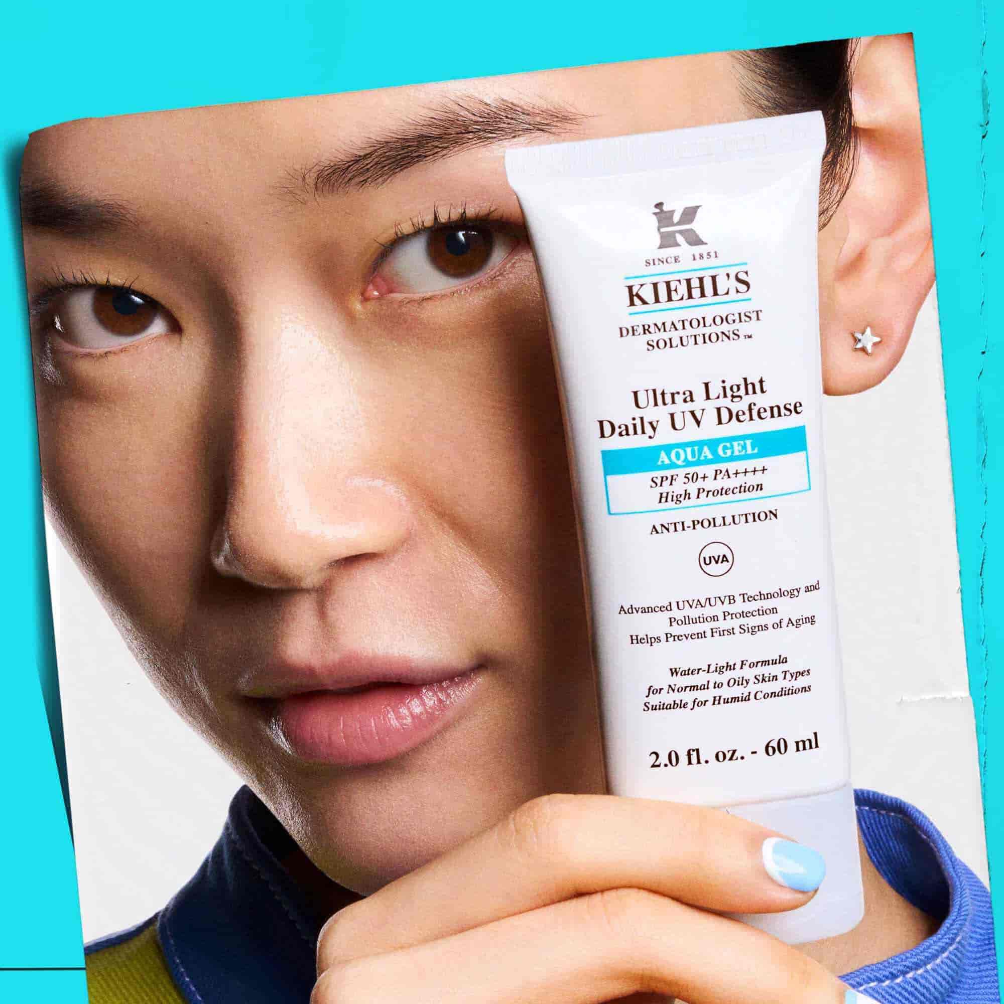 Modelka držiaca tubu Ultra Light Daily UV Defense Aqua Gel, ukazujuca jeho prenosnosť a jednoduche použitie.