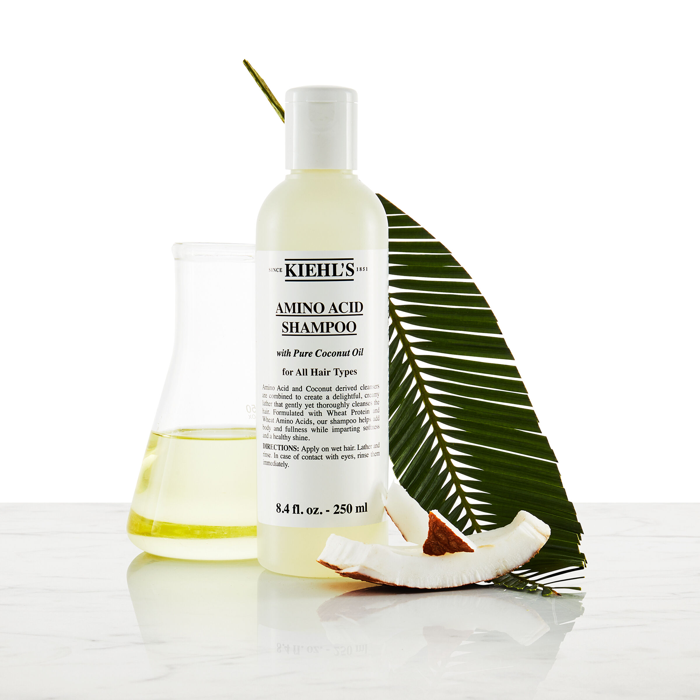 Model s fuzmi a fľašou šamponu Kiehl's Amino Acid Shampoo