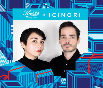 A man and woman stand side by side, both wearing black shirts, in front of a vibrant background featuring colorful gift boxes. The image is part of a collaboration between Kiehl's and iCiNORI.