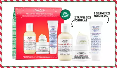 A festive gift set from Kiehl's featuring four hydrating products: two travel-size formulas and two deluxe-size formulas, all packaged in a decorative box with a holiday theme.