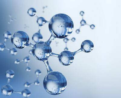 Close-up of transparent, spherical molecules against a soft blue background, illustrating a scientific or chemical concept.