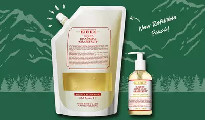 An image showcasing Kiehl's Grapefruit Liquid Hand Soap in two forms: a pump bottle and a new refillable pouch, with a nature-themed background and the text "New Refillable Pouch."