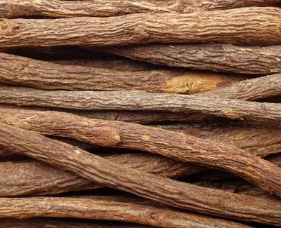 A close-up view of a pile of dried wood sticks, showcasing their textured surfaces and various shades of brown.