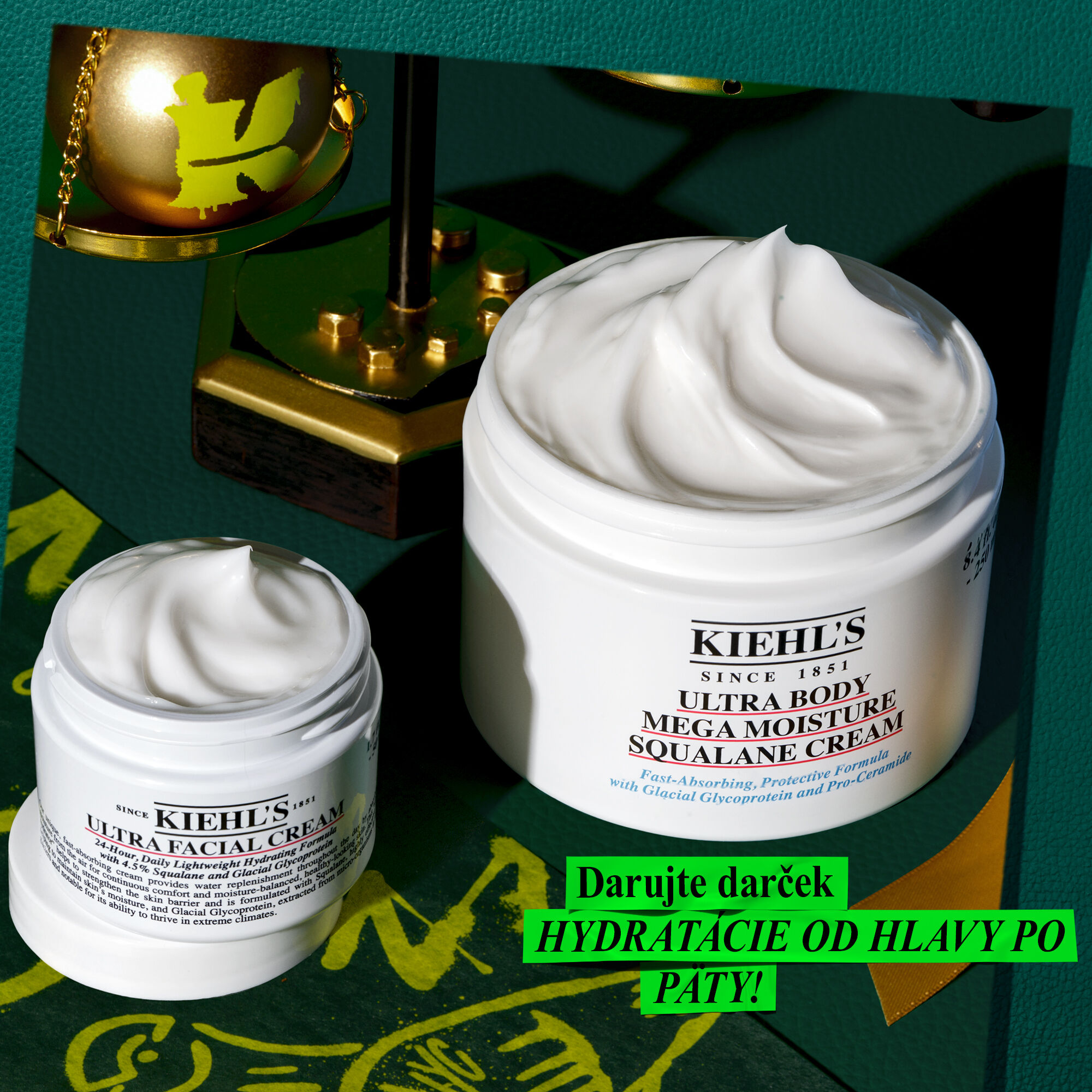 A dark green textured background features the gold text 'Kiehl's SHARING JOY SINCE 1851' with a green skull drawing. Three Kiehl's products are displayed: Calendula Herbal-Extract Toner, Rare Earth Pure Minimizing Clay Mask, and Ultra Facial Cream.
